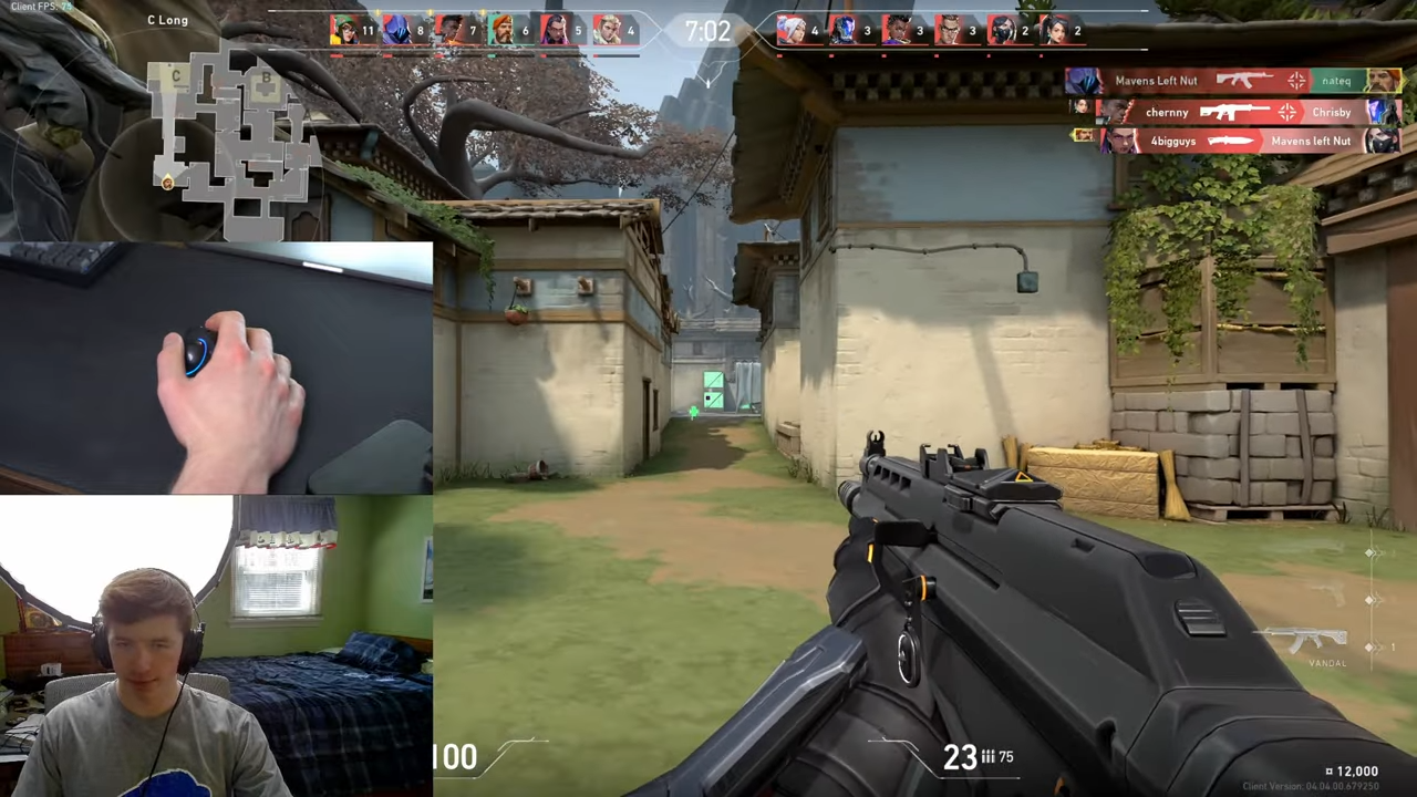 A streamer plays Valorant, with webcam and hand-cam views.