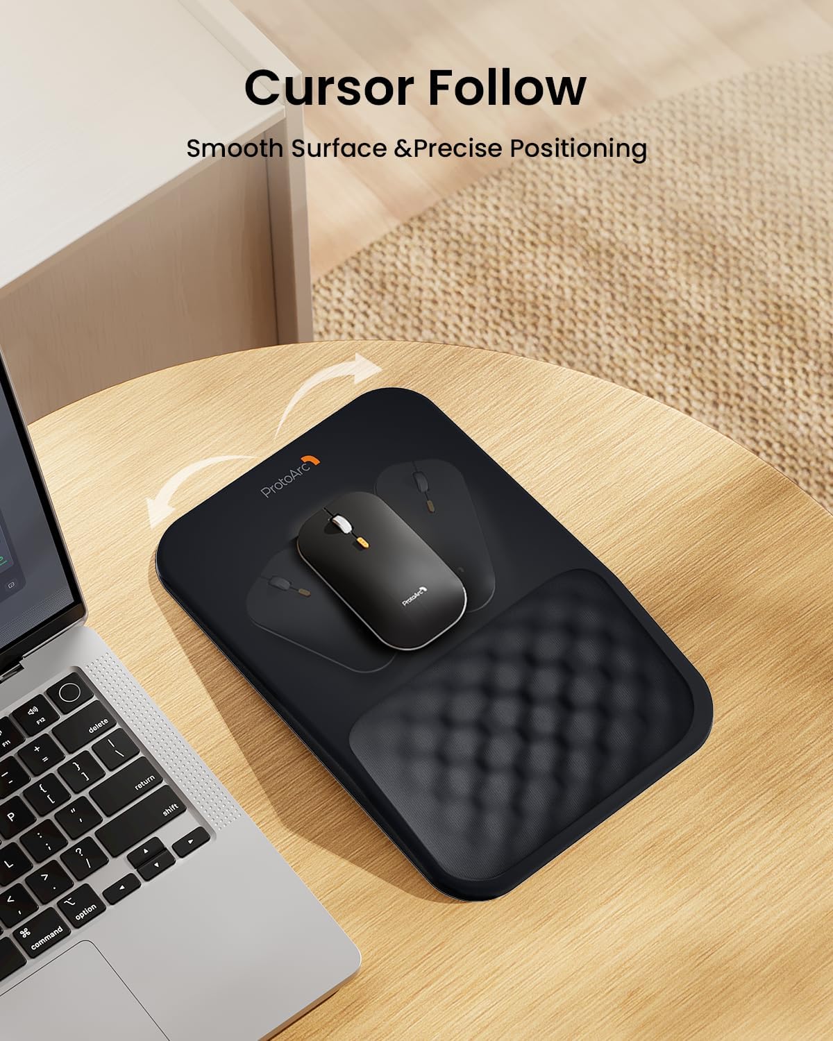 Black ProtoArc MP50 ergonomic mouse pad with smooth surface and textured wrist rest, alongside a laptop.