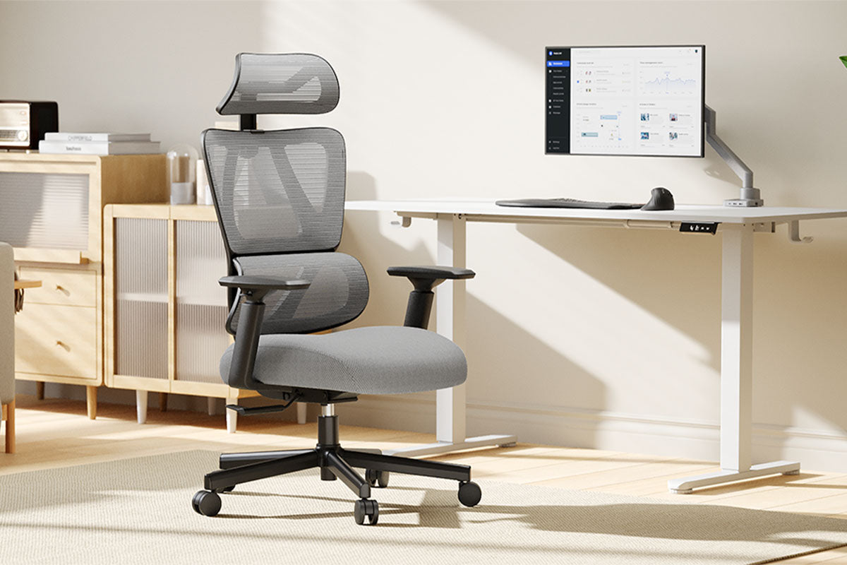 Ergonomic office chair next to a standing desk with a monitor