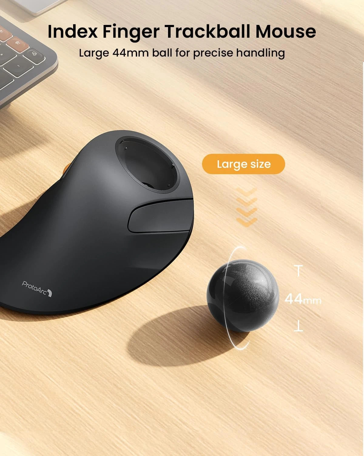 ProtoArc EM03 NL black ergonomic trackball mouse with a detached 44mm gray trackball on a wooden desk