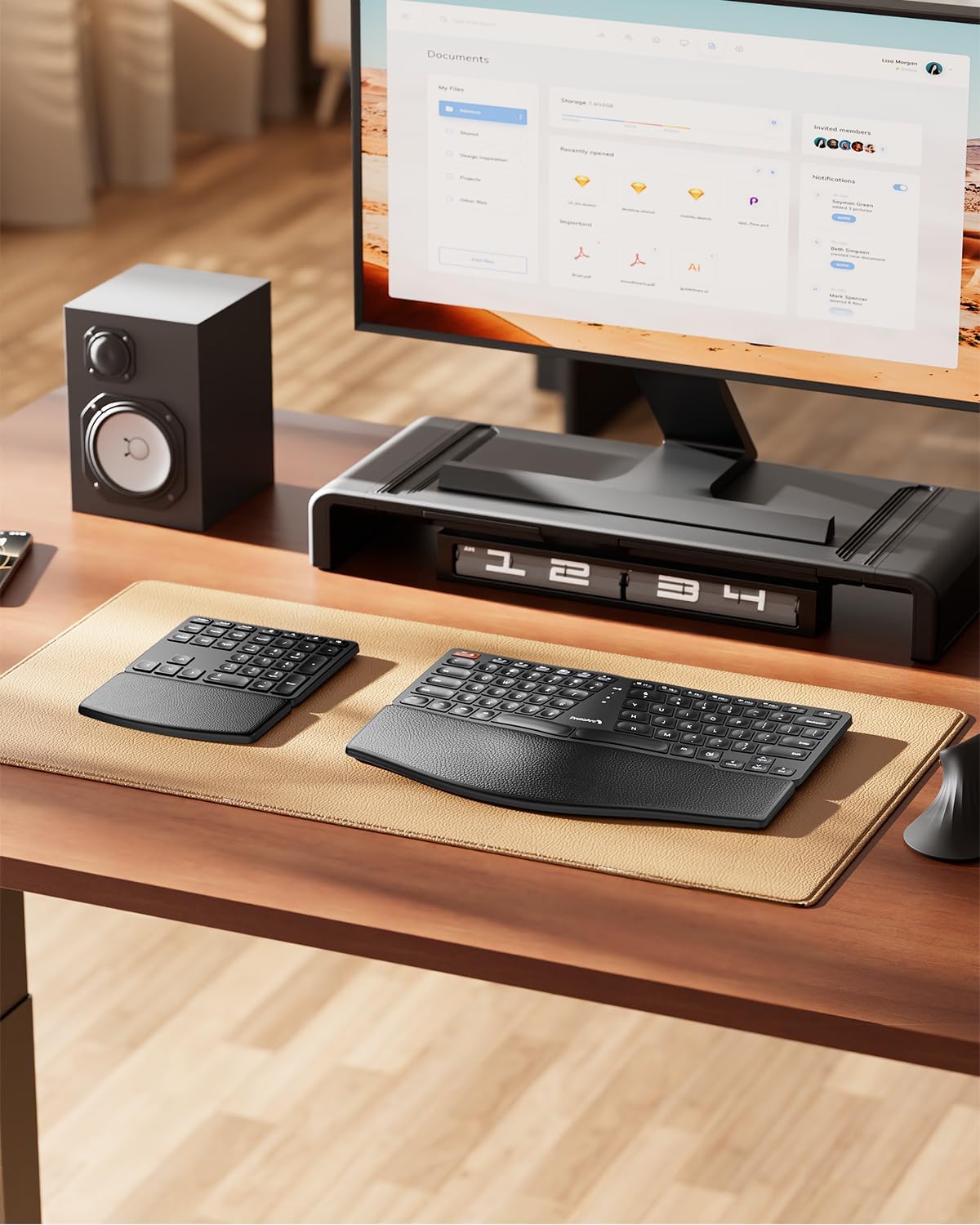 Black EK04 split ergonomic keyboard and numeric keypad with curved design on a desk mat, showing product setup.