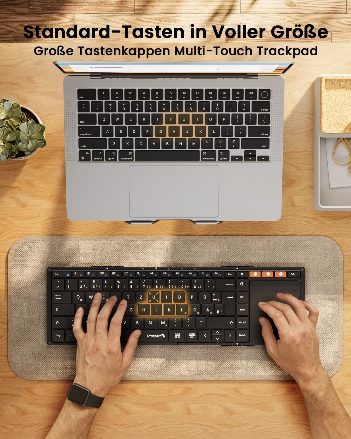 Black XK01 TP foldable Bluetooth keyboard with DE layout and touchpad, used with laptop.